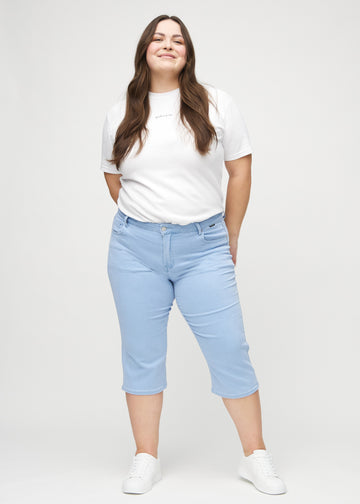 Fullt bilde av en plus-size-modell i lyseblå regular capris.