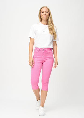 Skinny-capris til kvinner i pastellrosa jeansstoff, fargen Flamingos. Helhetsbilde av en modell med capris på.