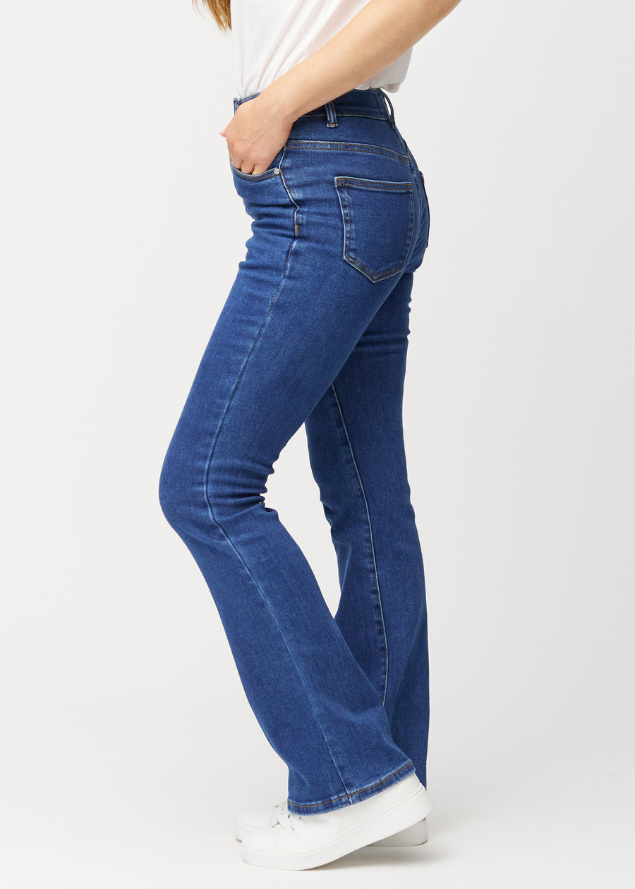 Mørkeblå mid-rise bootcut-jeans i fargen Oceans. Sett fra siden på en modell.
