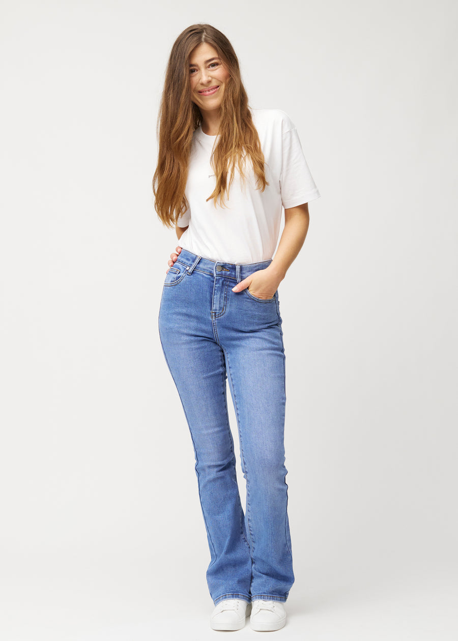 Blå mid-rise bootcut-jeans i fargen Rivers. Helhetsbilde av en modell med jeansene på.