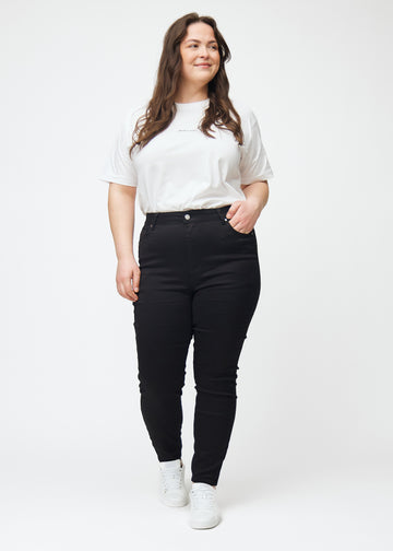Dette er et fullt bilde av en plus size-modell iført svarte high rise skinny jeans til kvinner i fargen Ravens.