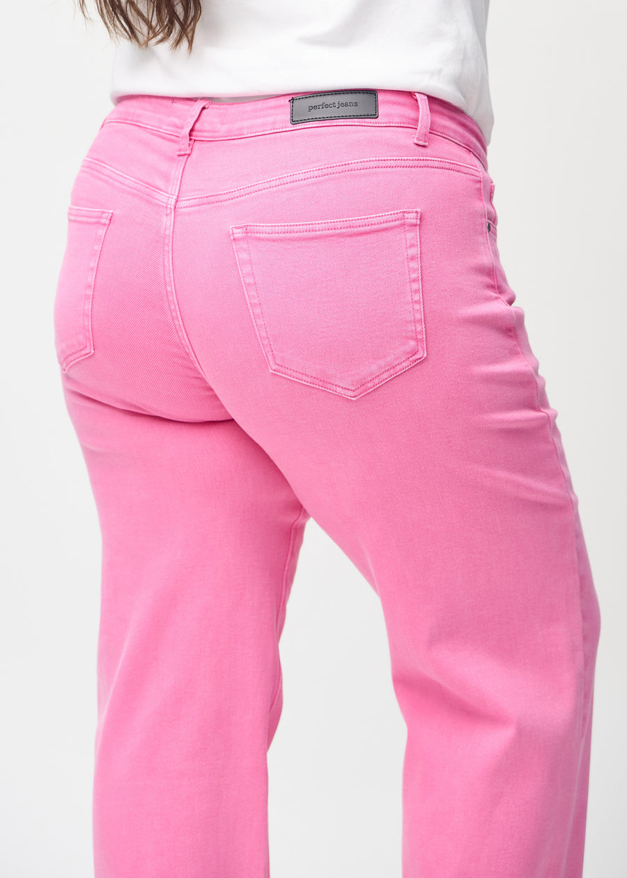 Loose-jeans til kvinner i lyserosa, fargen Flamingos. Nærbilde bakfra på en plus size-modell, som viser passform og detaljer.