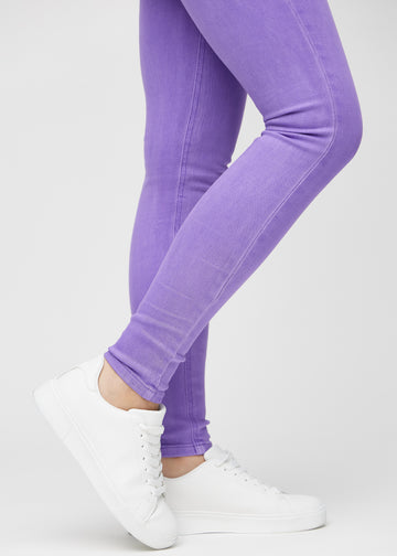Skinny-jeans til kvinner i lilla, fargen Lavenders. Nærbilde ved anklene på en modell, som viser de tettsittende benåpningene.