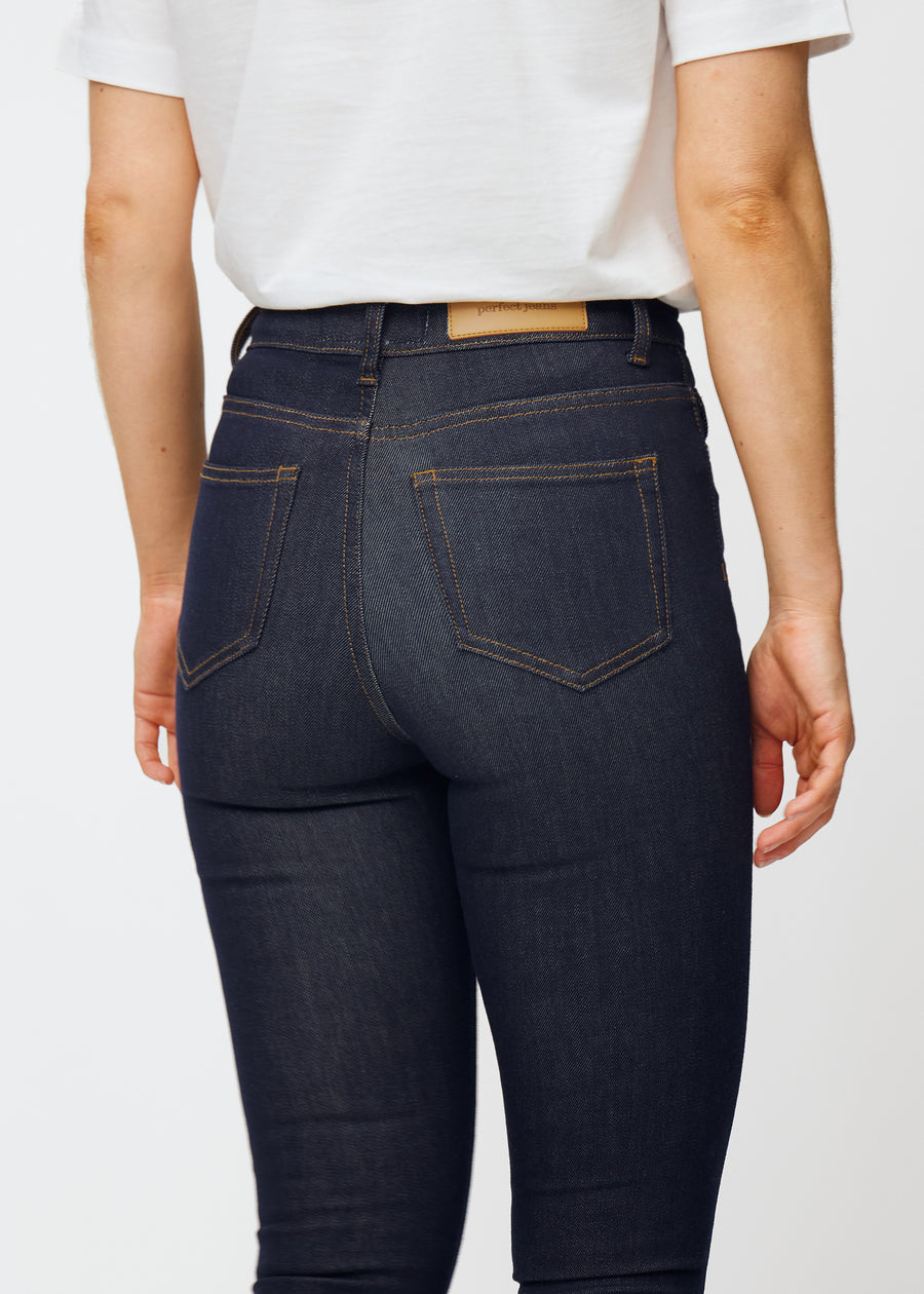 Dyp mørkeblå denim jeans til kvinner i fargen Midnights sett bakfra på nært hold for å vise passform og detaljer.
