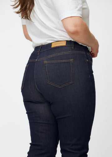 Dyp mørkeblå denim jeans til kvinner i fargen Midnights sett bakfra på nært hold på plus-size-modell.