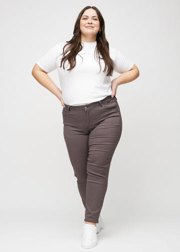 Slim-jeans til kvinner i gråbrun, fargen Thunders. Helhetsbilde av en plus size-modell med jeansen på.