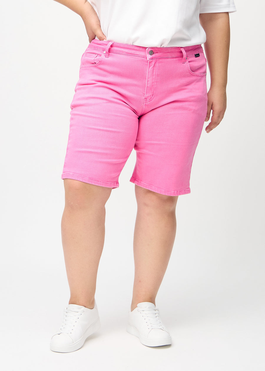 Lyserosa regular middle shorts, modellnavn Flamingos, som går rett ned langs benet og slutter rett over kneet på en plus-size-modell, sett forfra.