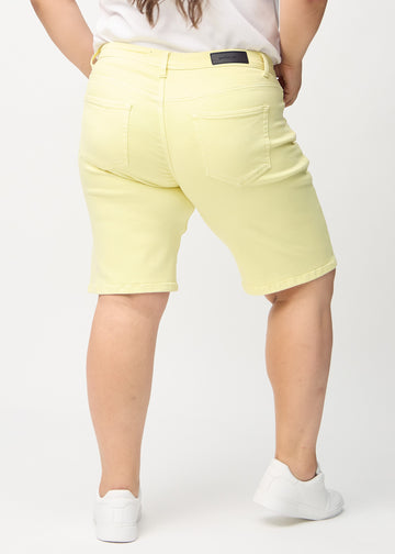 Lysegule regular middle shorts sett bakfra på en plus-size-modell, slik at man kan se hele produktet.
