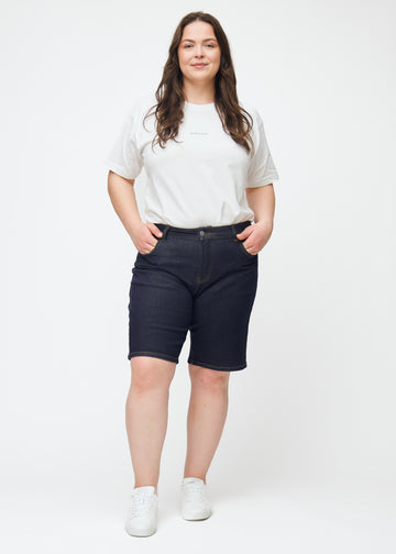 Helbilde av plus-size modell i dyp mørkeblå denimshorts til dame i fargen Midnights med regular passform.