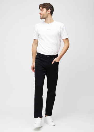 Fullt bilde av modell i svarte regular jeans.