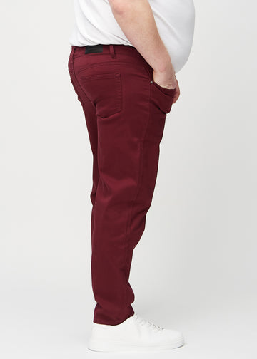 Mørkerøde regular jeans sett fra siden på en plus-size-modell.