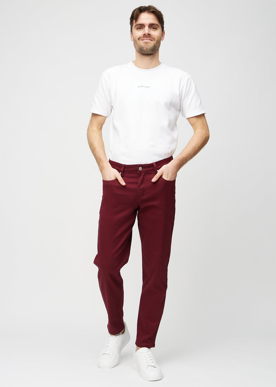Fullt bilde av modell i mørkerøde regular jeans.