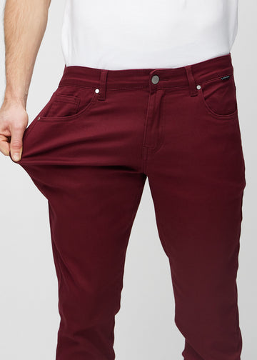 Modell strekker jeansene ved låret for å vise materialets stretch.